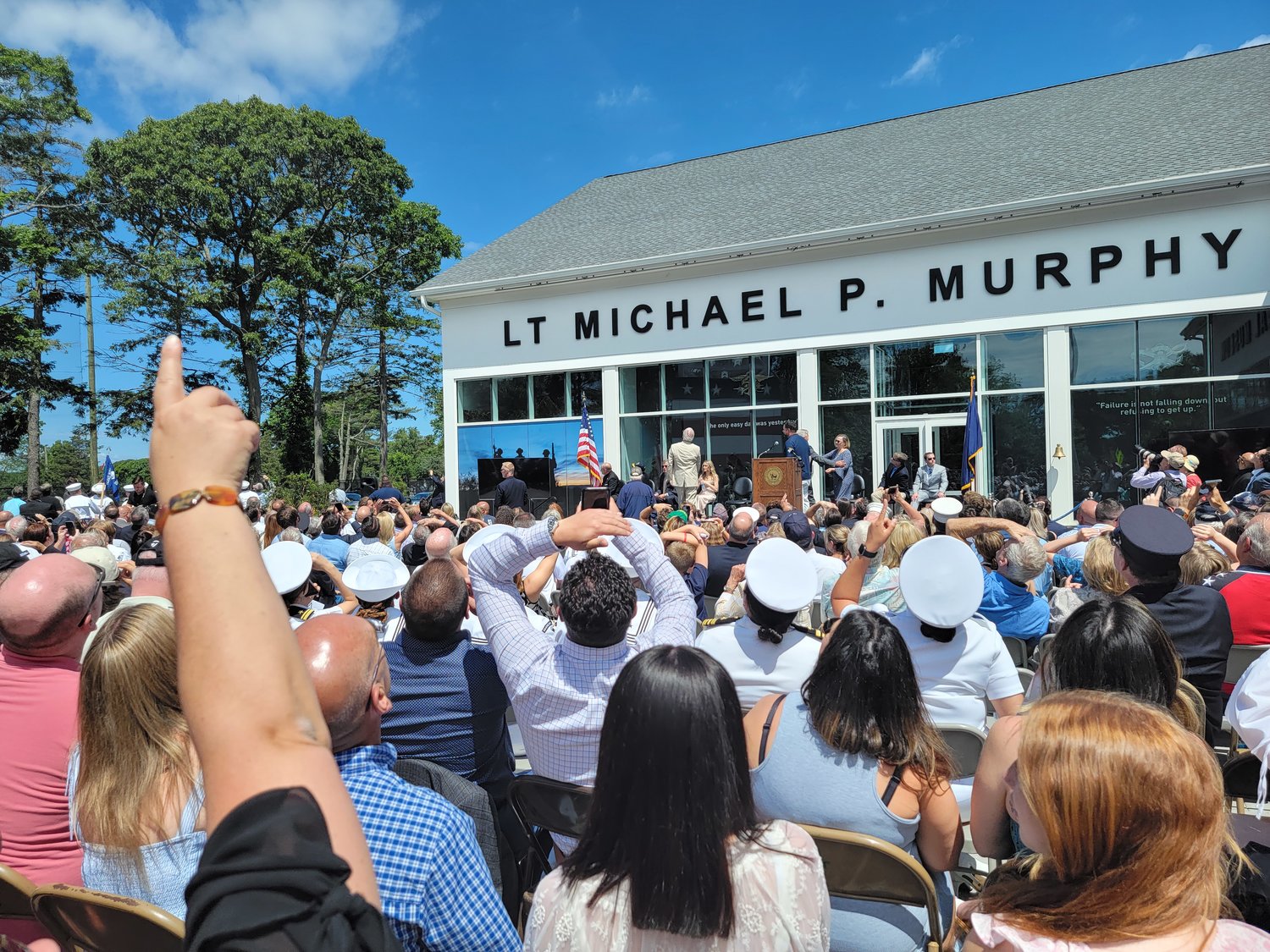 Over 1,000 attendees came to the ribbon cutting of the Lt. Michael Murphy Navy SEAL Museum. The crowd was treated to a special descent by the Navy’s Leapfrog team, who parachuted down to the West Sayville Golf Course driving range, next door to the museum.